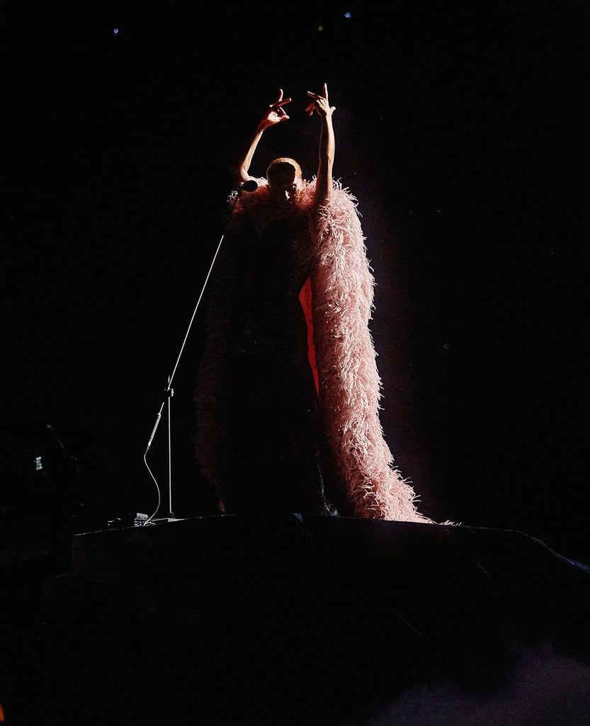 Céline Dion wearing a custom Givenchy dusty-pink shredded-organza embroidered cape during her Paris residency.