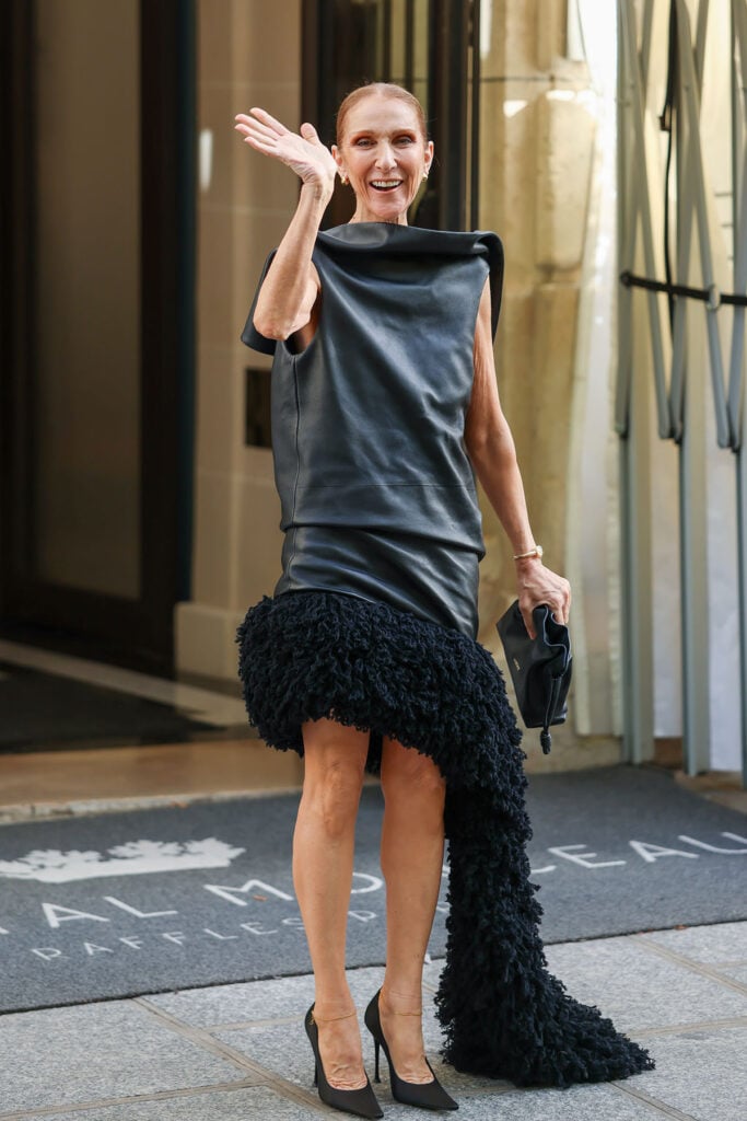 Celine Dion wears a black Loewe fall 2026 leather dress while leaving her hotel in Paris.