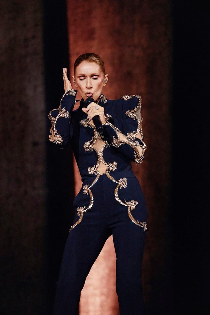 Céline Dion wearing a custom black Schiaparelli Haute Couture look during her Paris residency.
