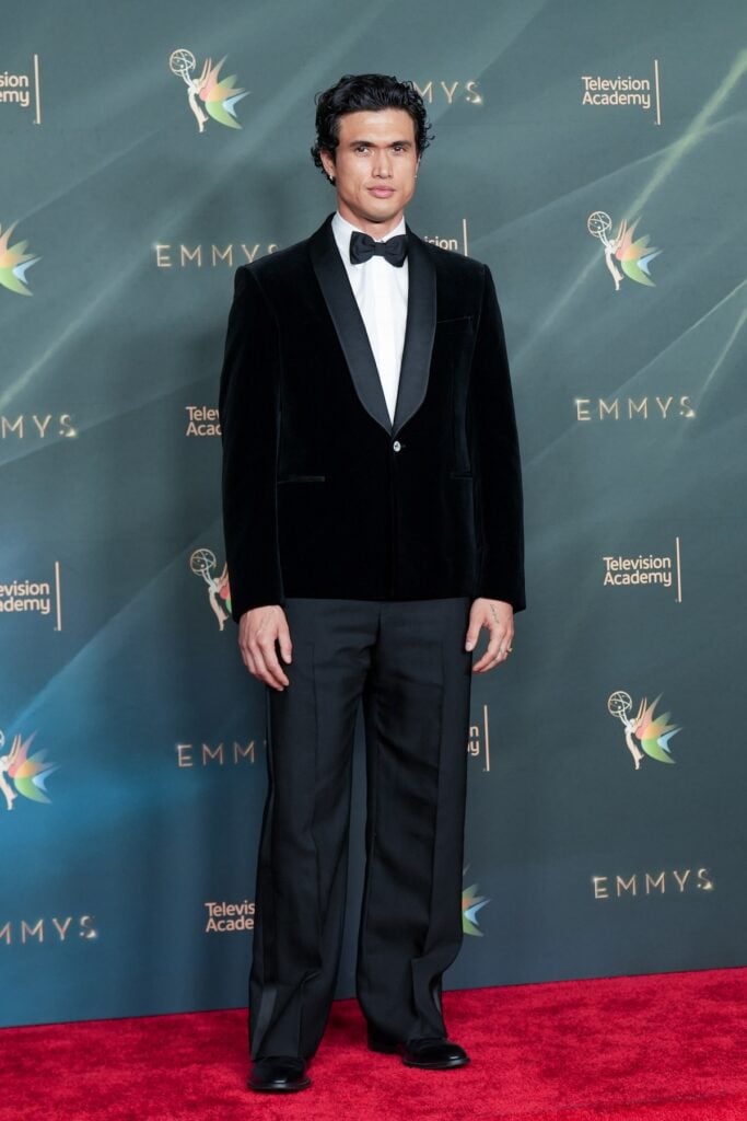 Charles Melton wearing a black velvet Louis Vuitton tuxedo at the 2026 Creative Arts Emmy Awards.