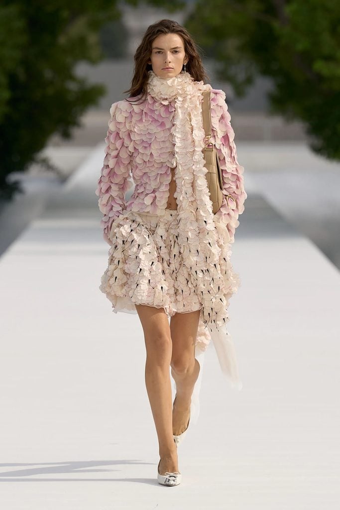 Dior Spring 2027 Look 4 featuring a silk-petal jacket, skirt and floral scarf on the runway during Paris Fashion Week.