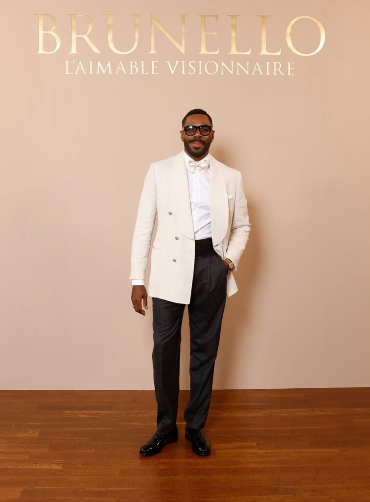 Colman Domingo wears an ivory Brunello Cucinelli double-breasted jacket with black trousers at the Brunello Cucinelli Paris boutique celebration.