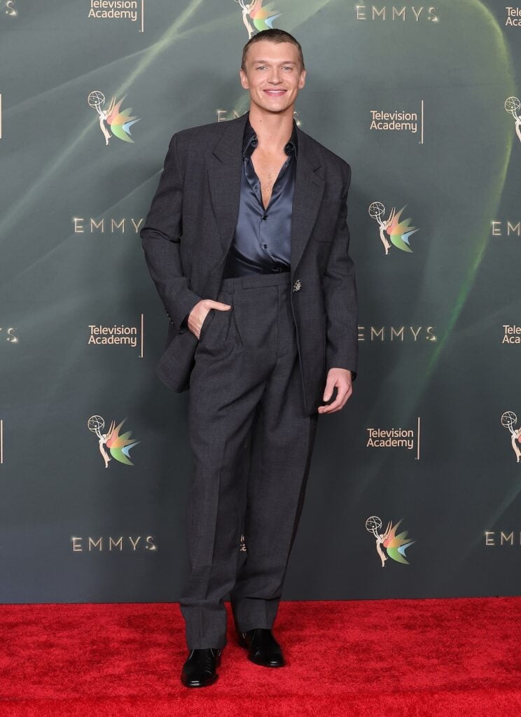 Connor Storrie wearing a grey Saint Laurent suit at the 2026 Creative Arts Emmy Awards.