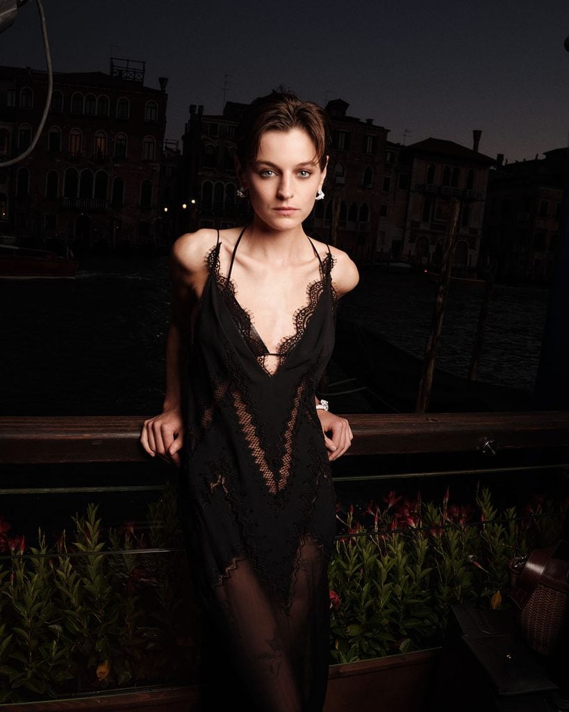 Emma Corrin wearing a black Tom Ford by Haider Ackermann lace dress with Cartier jewellery at the Cartier Cinema Club in Venice.