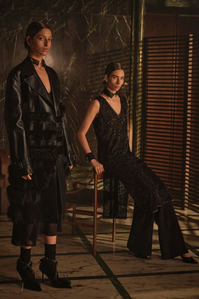 A model wears the black Fendi Resort 2027 look with its distinctive gold collar and cuffs.