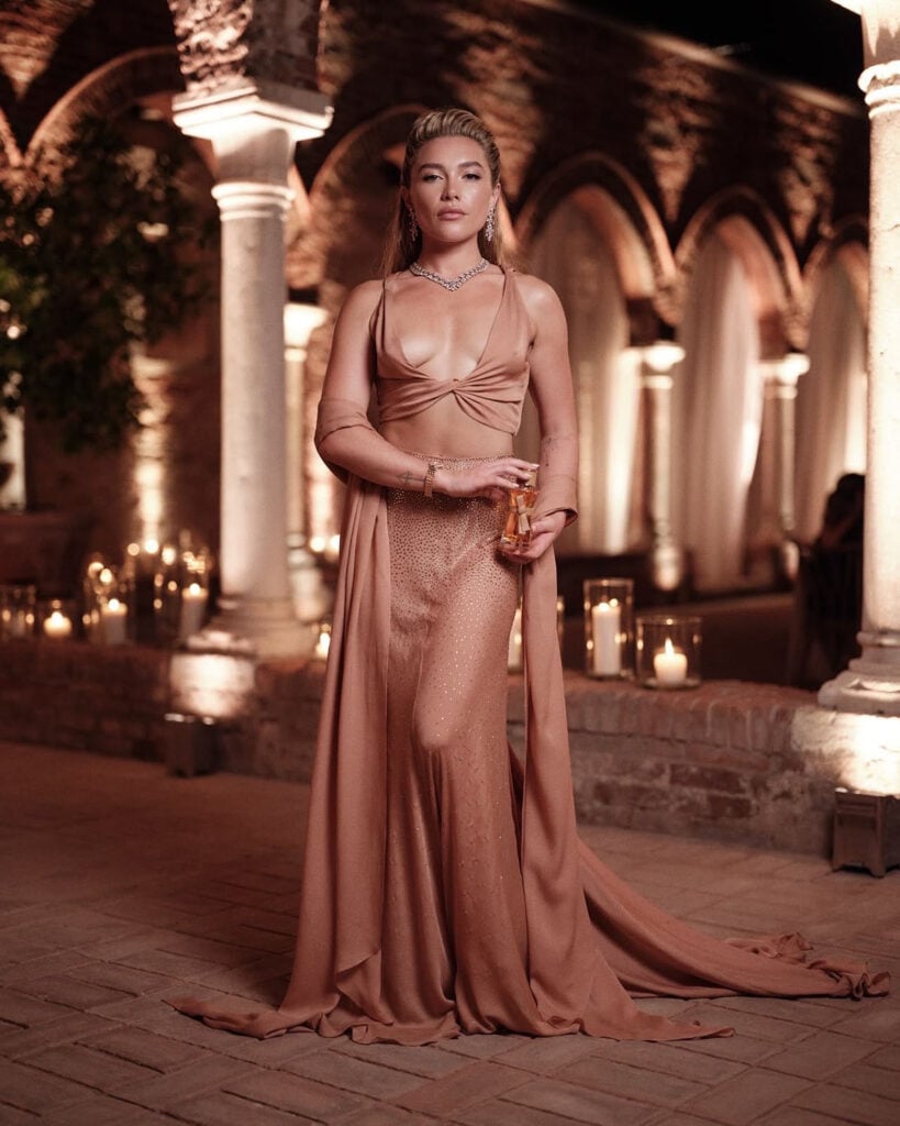 Florence Pugh holding Max Mara Le Parfum as the face of the house’s new fragrance campaign.