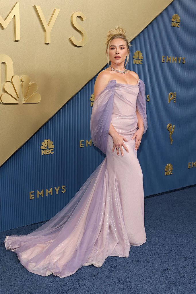 Florence Pugh in a lavender Vivienne Westwood gown featuring a tulle overlay and sweeping train on the 2026 Emmys red carpet.