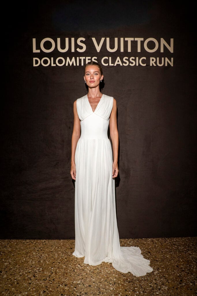 Giulia Maenza wearing a white Louis Vuitton pleated gown at the Louis Vuitton Dolomites Classic Run 2026 in Venice.