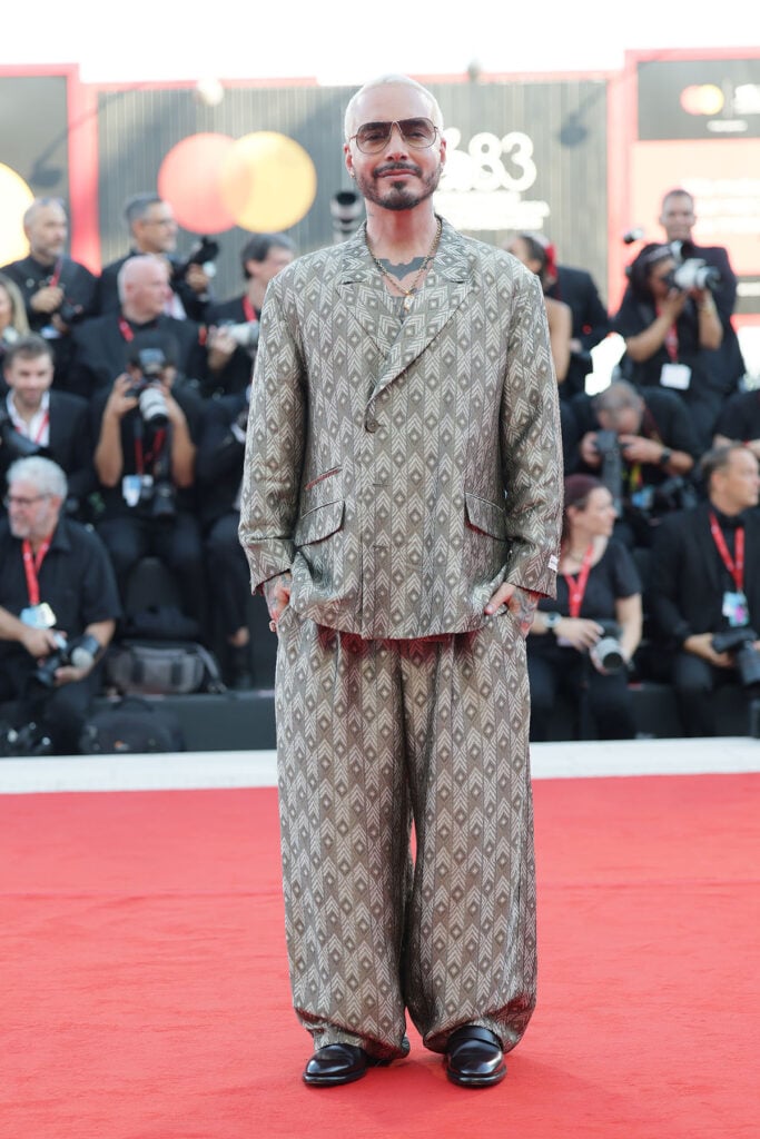 J Balvin wearing an oversized patterned Giorgio Armani suit at the 2026 Venice Film Festival.