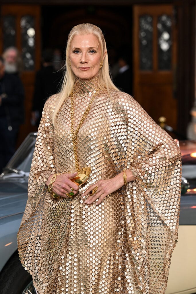 Joely Richardson carrying a gold clutch with her sequinned Taller Marmo kaftan at The Gentlemen Season Two premiere.