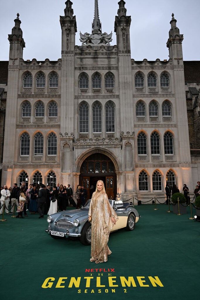 Joely Richardson wearing a floor-length gold Taller Marmo kaftan at Guildhall for The Gentlemen Season Two world premiere.