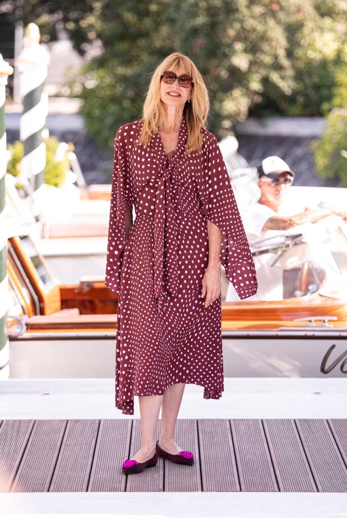 Laura Dern wears a burgundy polka-dot Stella McCartney dress with Roger Vivier ballerinas in Venice.
