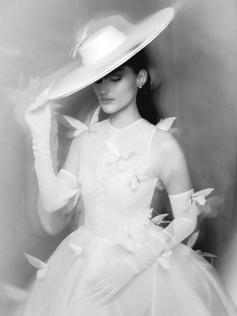 Liza Soberano wears Robert Wun’s white butterfly couture gown with the matching wide-brimmed hat during the 2026 Venice Film Festival.
