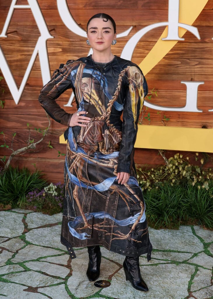 Maisie Williams wears a Maison Margiela leather top and skirt with an avian skeletal print at the Practical Magic 2 LA premiere.