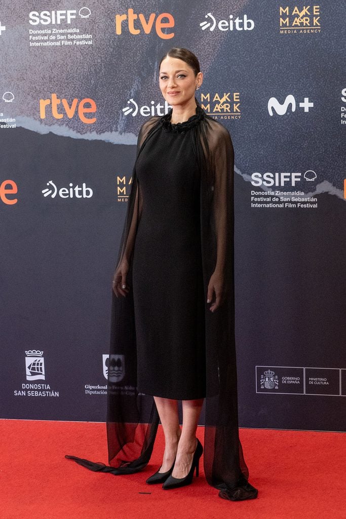 Marion Cotillard wearing a black Chanel Haute Couture dress with a sheer floor-length overlay at the 7h40 ce Matin là screening in San Sebastián.