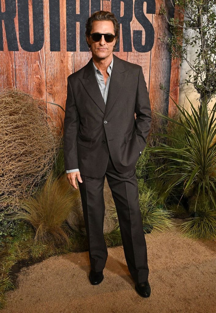 Matthew McConaughey wears a brown Prada suit with a grey shirt to the Brothers premiere in Los Angeles.