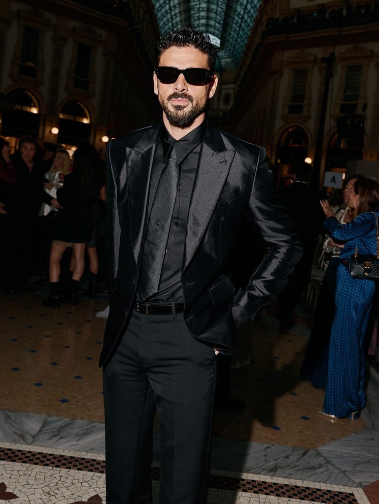 Michele Morrone wearing an all-black Dolce & Gabbana satin suit with sunglasses at Vogue World Milano