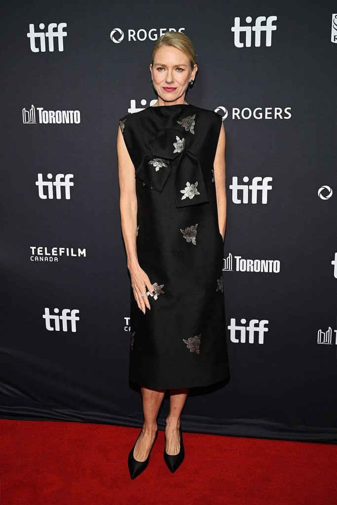 Naomi Watts wearing a black Celine dress with silver floral embellishments at The Housewife premiere during TIFF 2026.