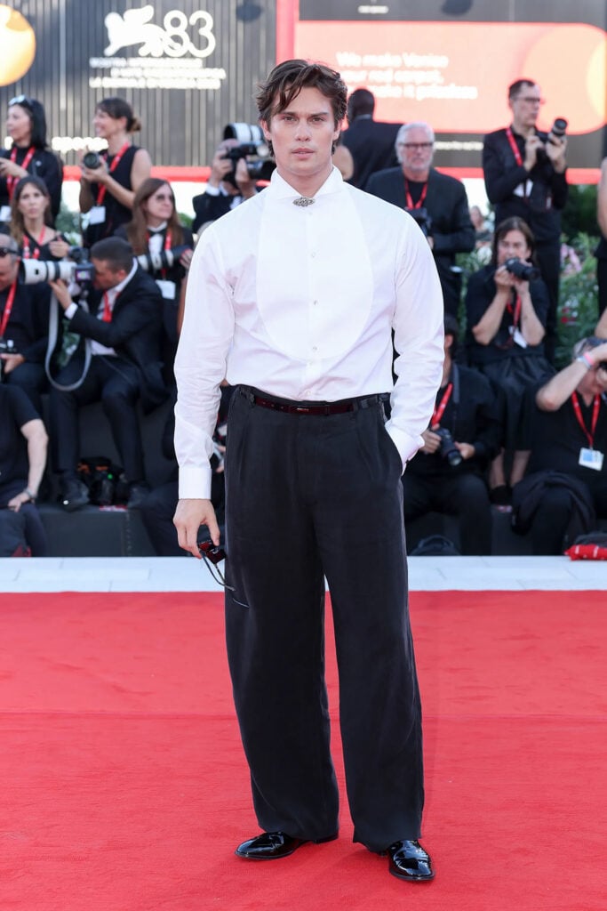 Nicholas Galitzine wearing an Emporio Armani evening look with a white shirt and black trousers at the 2026 Venice Film Festival.
