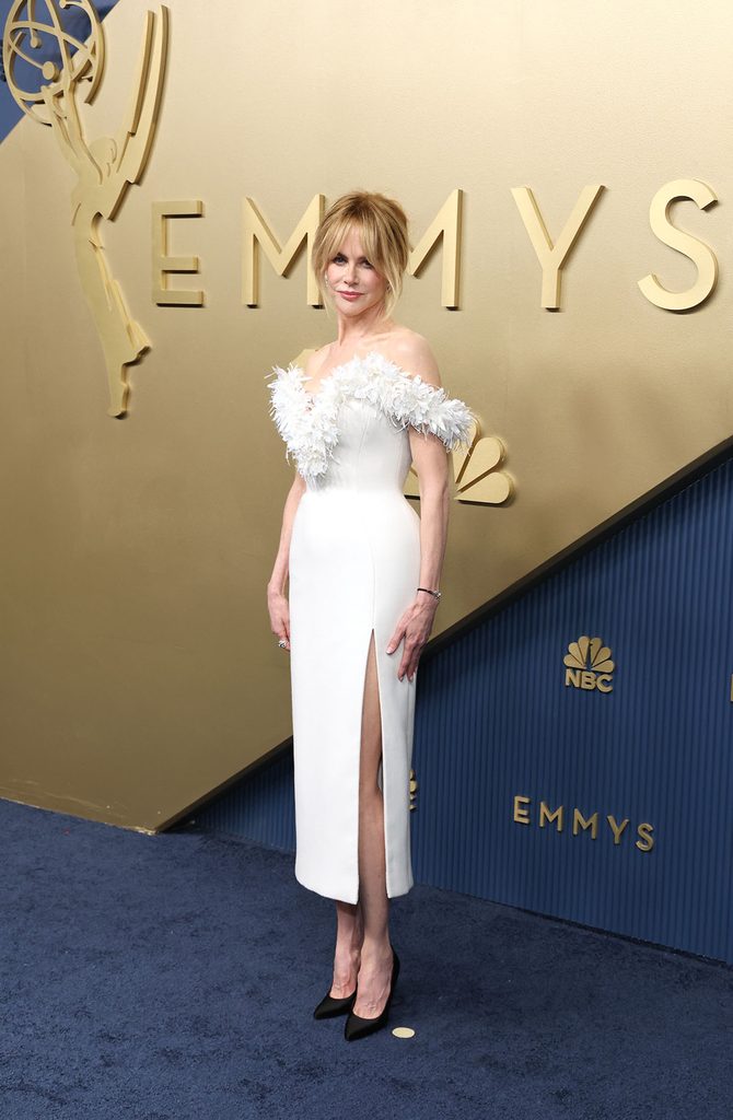 Nicole Kidman wearing black satin Chanel pumps with her custom white floral dress at the 2026 Emmy Awards.
