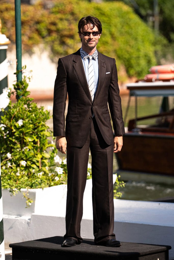 Patrick Schwarzenegger wearing a chocolate-brown Tom Ford by Haider Ackermann suit at the Bunker photocall during the 2026 Venice Film Festival.