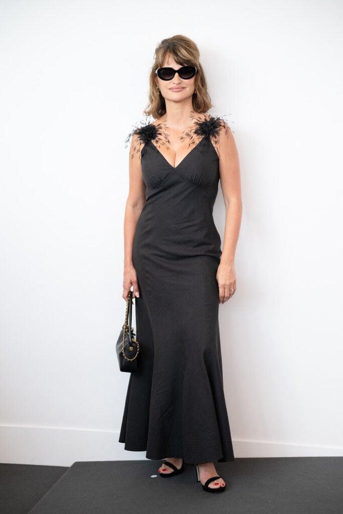 Penélope Cruz wearing a feather-embellished black Chanel dress at the Bunker photocall during the 2026 Venice Film Festival.