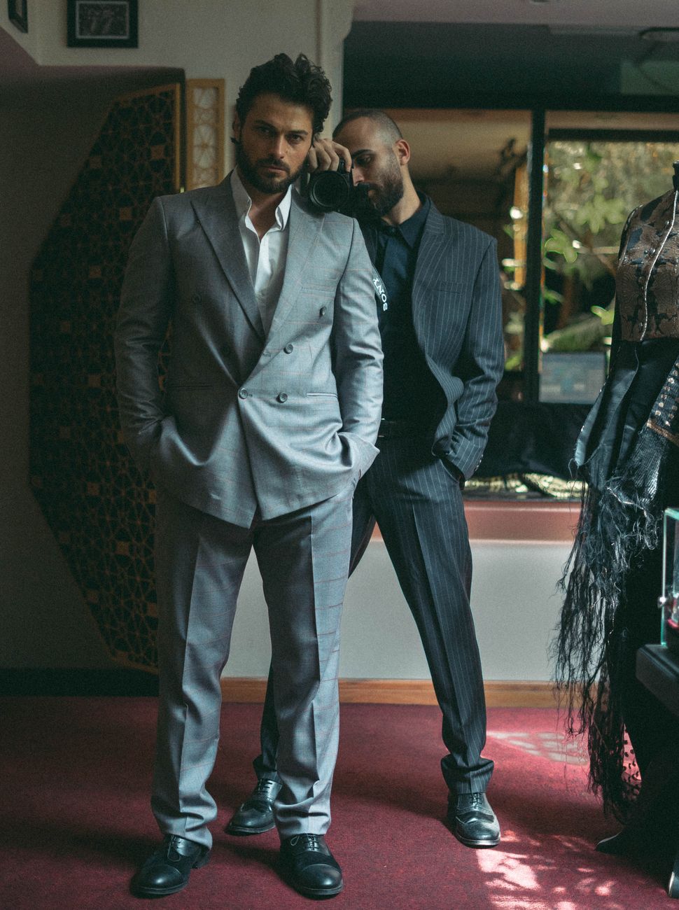 stylish men in formal suits indoors