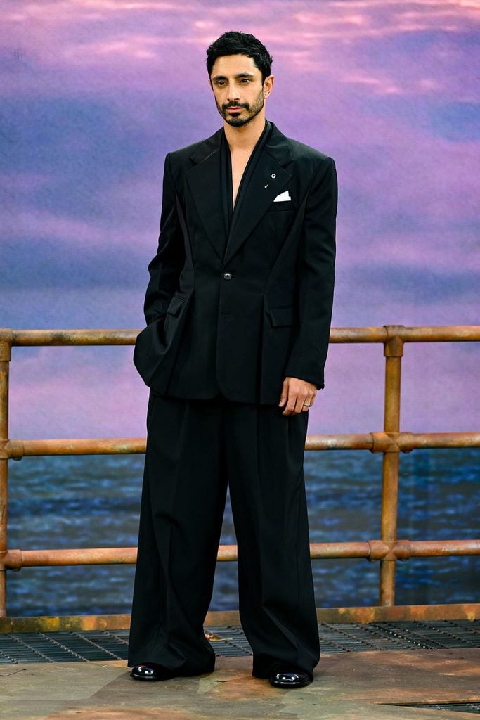 Riz Ahmed wearing an oversized black Givenchy by Sarah Burton suit with wide-leg trousers at the Digger premiere in London