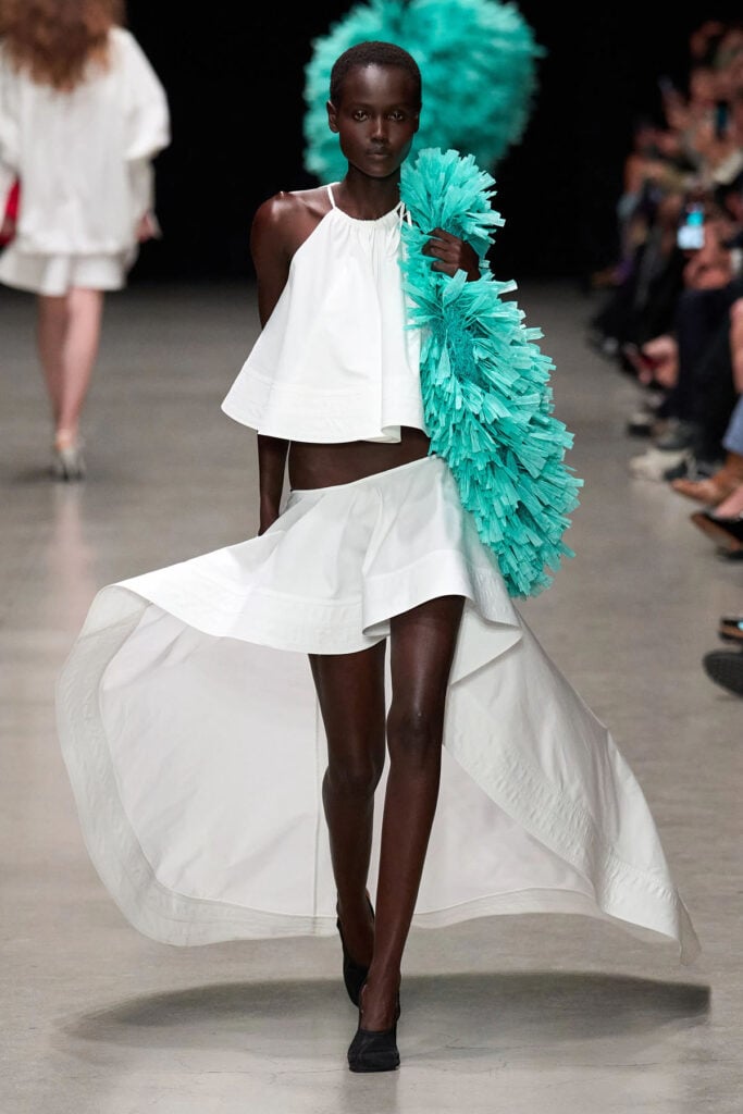 Stella McCartney Spring 2026 white asymmetric dress presented on the runway.