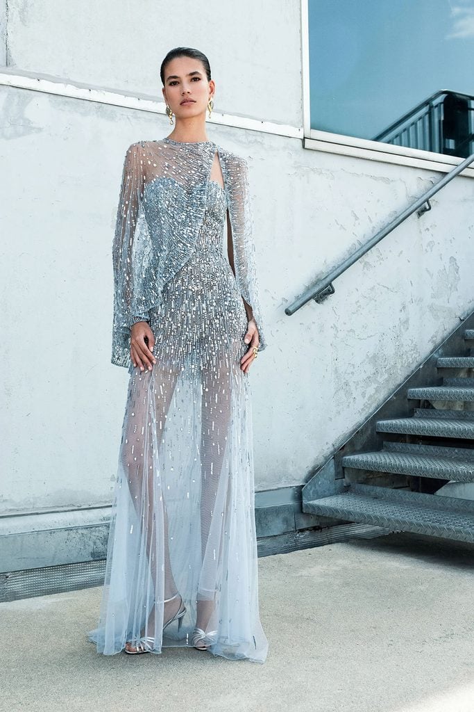 Zuhair Murad Resort 2027 ice-blue sheer gown with silver sequin embellishments, a draped cape and floor-length skirt.