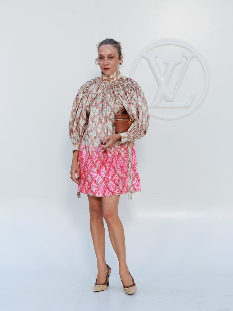Chloë Sevigny wearing a floral Louis Vuitton mini dress at the Spring-Summer 2027 show at the Louvre in Paris.
