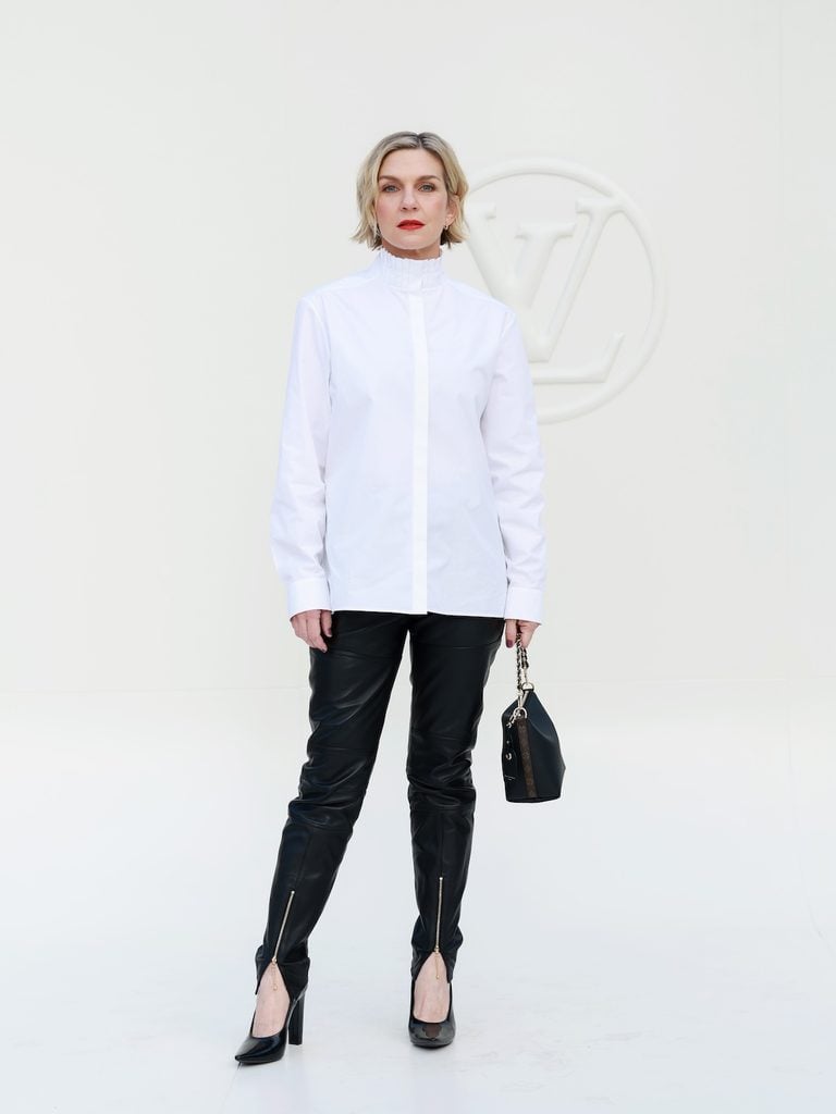 Rhea Seehorn wearing a white Louis Vuitton shirt with black leather trousers at the Spring-Summer 2027 show in Paris.