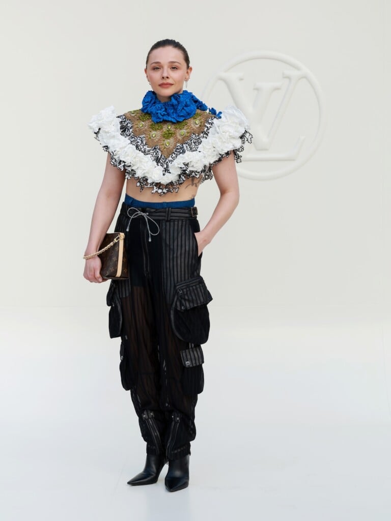 Chloë Grace Moretz wearing a ruffled Louis Vuitton top with sheer cargo trousers at the Spring-Summer 2027 show in Paris.