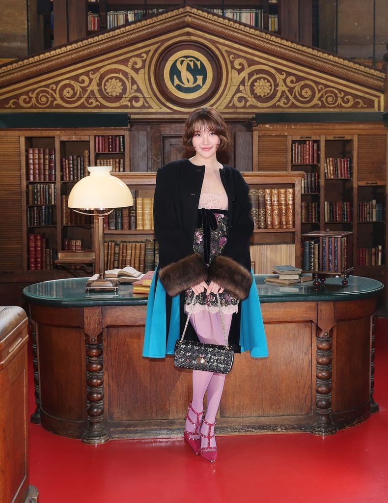 Freen Sarocha wearing a fur-trimmed Valentino look at the Valentino Spring 2027 show in Paris.