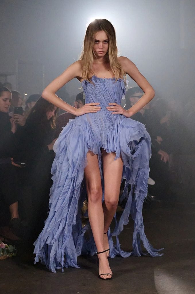 Model wearing the purple distressed pleated silk MYAT Fall 2026 dress on the runway.