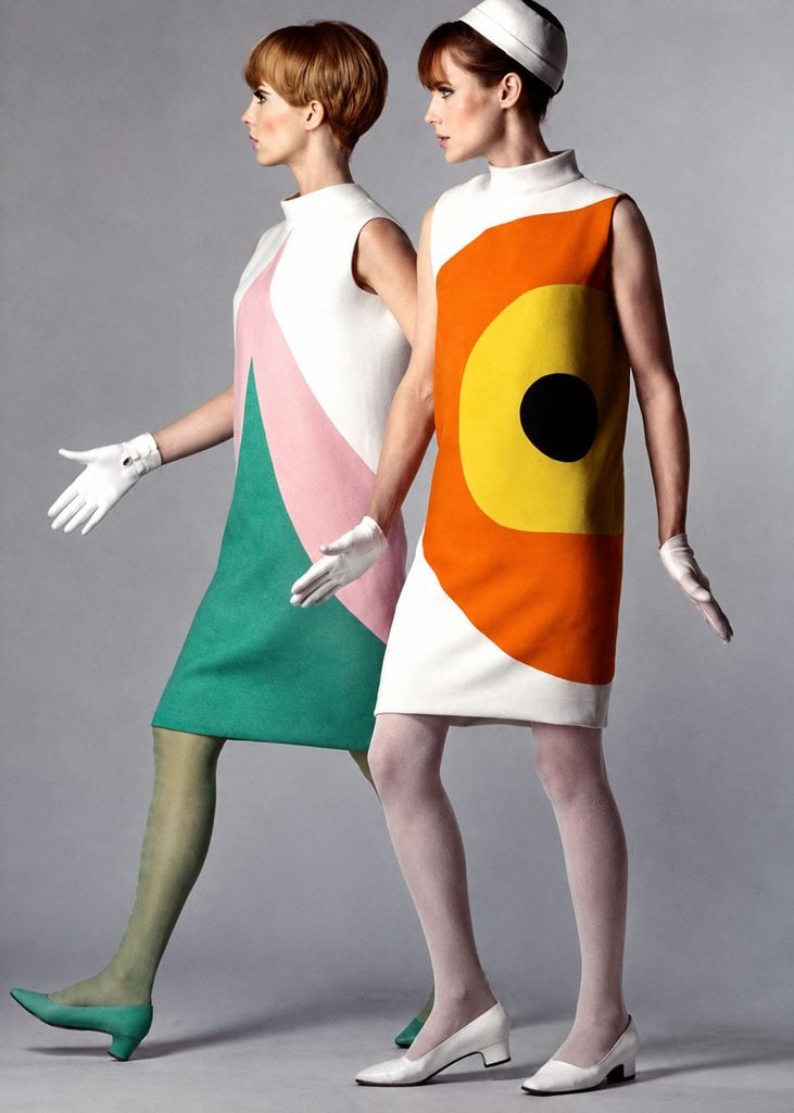 Two models wearing geometric Pierre Cardin dresses from 1966, including the original orange and yellow Target design.
