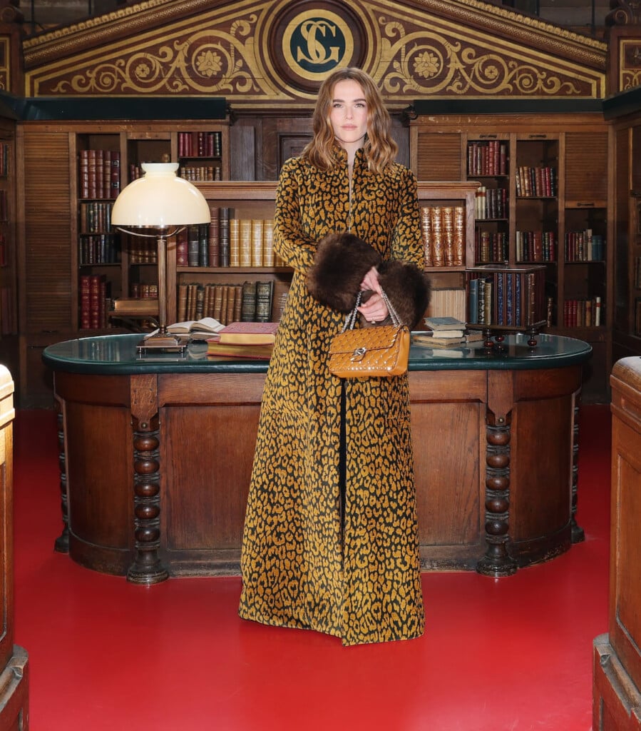 Zoey Deutch wearing a fur-trimmed animal-print Valentino coat at the Valentino Spring 2027 show in Paris.