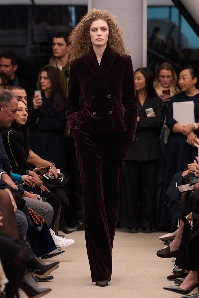 Alaïa Fall 2026 runway model wearing the burgundy velvet double-breasted suit later seen on Saja Kilani at the Rome Film Festival.
