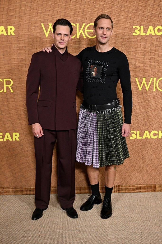 Bill Skarsgård in a burgundy Dolce & Gabbana suit alongside Alexander Skarsgård in custom Chopova Lowena at the 'Wicker' premiere in Los Angeles.