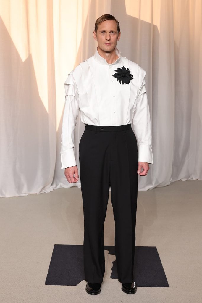 Alexander Skarsgård in a Balenciaga white shirt with black floral appliqué and black trousers at the 2026 Academy Museum Gala