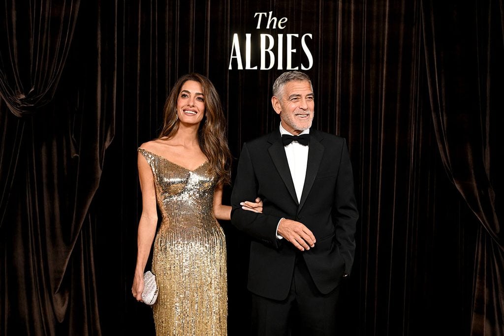 Amal Clooney in a gold Gucci fringed gown alongside George Clooney in a Gucci tuxedo at the 2026 Albies.