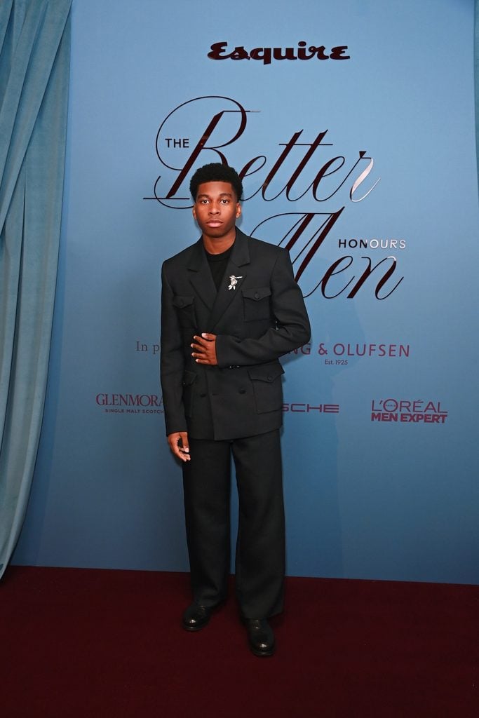 Amari Bacchus wearing Denzil Patrick double-breasted tailoring with patch pockets and a decorative brooch at Esquire UK's Better Men Honours in London.