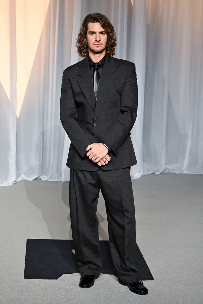 Andrew Garfield wearing an oversized charcoal Ferragamo suit with a black leather tie at the 2026 Academy Museum Gala