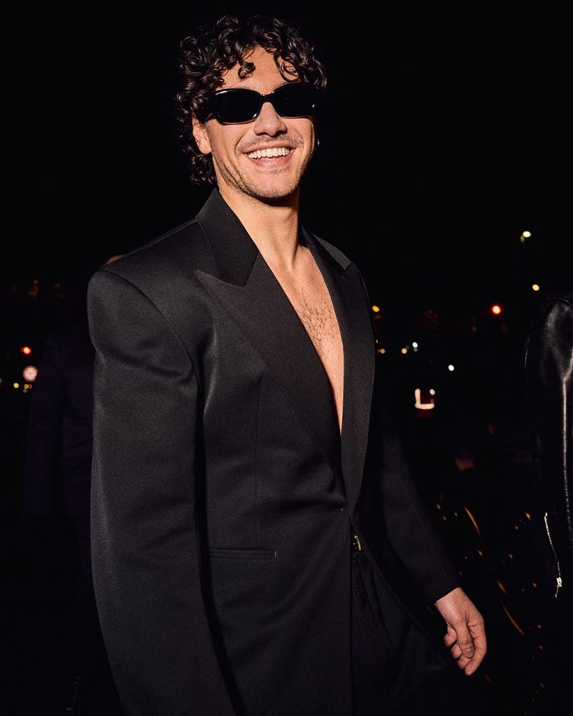 Belmont Cameli wearing black Saint Laurent tailoring and sunglasses at the Spring 2027 show in Paris.