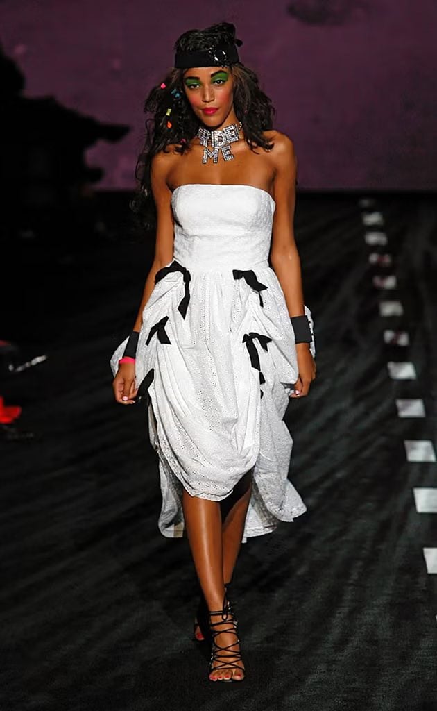 Betsey Johnson Spring 2011 runway model wearing the bow-adorned dress later worn by Mckenna Grace during The Hunger Games: Sunrise on the Reaping press tour in New York.