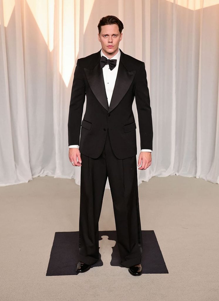 Bill Skarsgård wearing a black Dolce & Gabbana tuxedo with a bow tie at the 2026 Academy Museum Gala in Los Angeles
