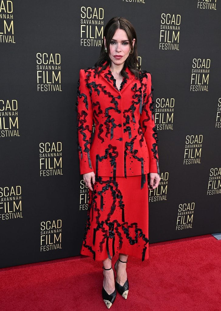 Billie Piper wears a red Lurline ribbon-embellished suit at the 2026 SCAD Savannah Film Festival in Georgia.