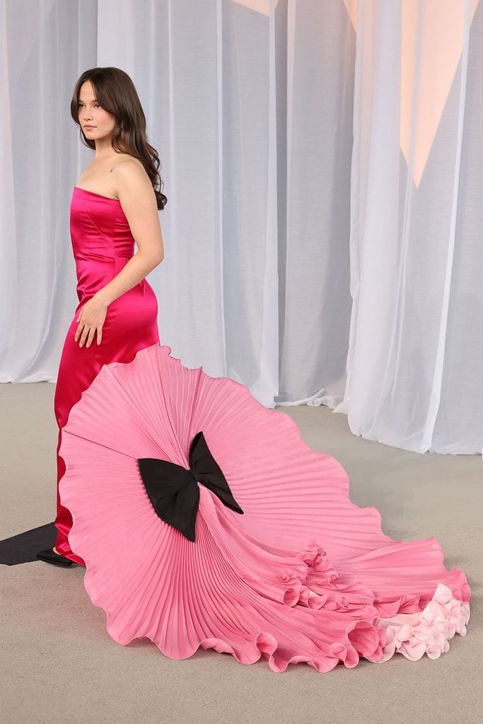 Back of Cailee Spaeny in a fuchsia Valentino Spring 2027 gown with a pleated pink train at the 2026 Academy Museum Gala