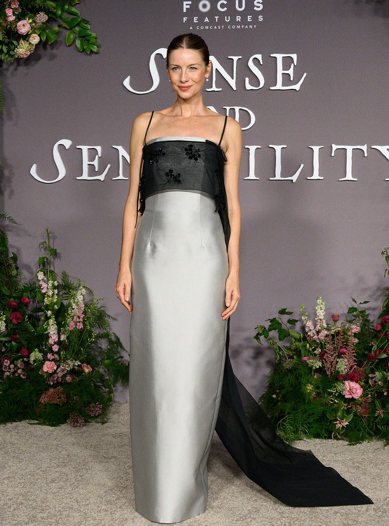 Caitríona Balfe wearing a custom Prada pearl-grey silk-wool column dress with an embroidered black organza train at the 'Sense and Sensibility' LA premiere.