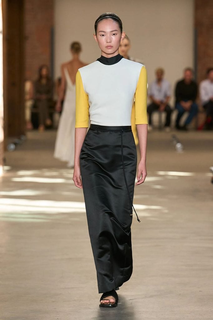 Model wearing a yellow, white and black colour-block ensemble from Veronica Leoni's Calvin Klein Spring 2027 runway collection.